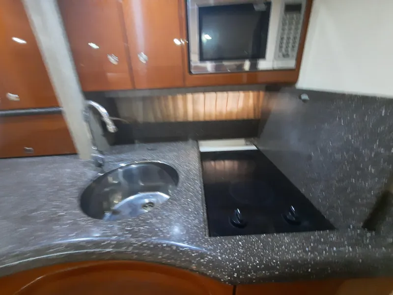 Slide: The Image of 2008 Formula 40 PC yacht kitchen with sink, stovetop, and microwave. - 24