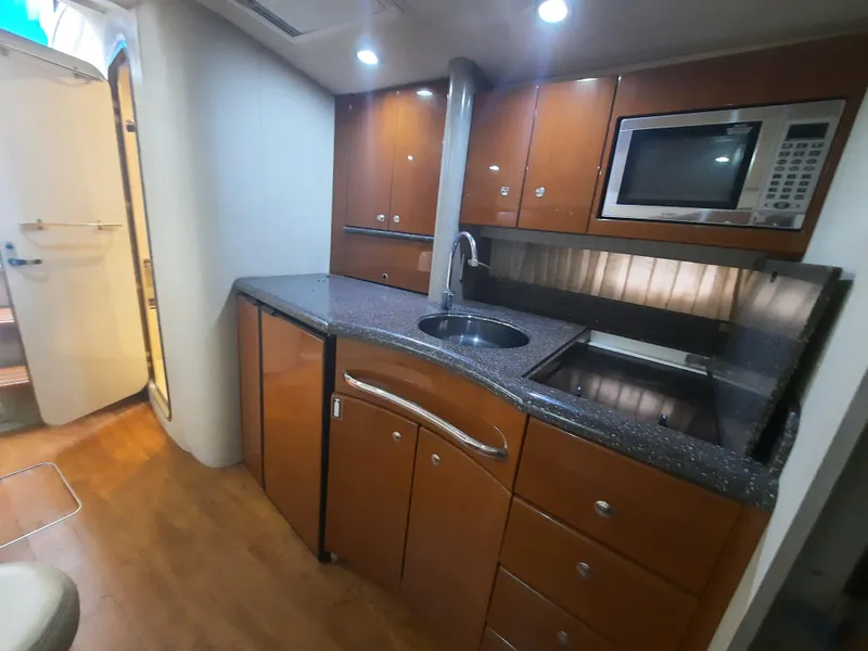 Slide: The Image of 2008 Formula 40 PC yacht kitchen with modern appliances and wooden cabinetry. - 25