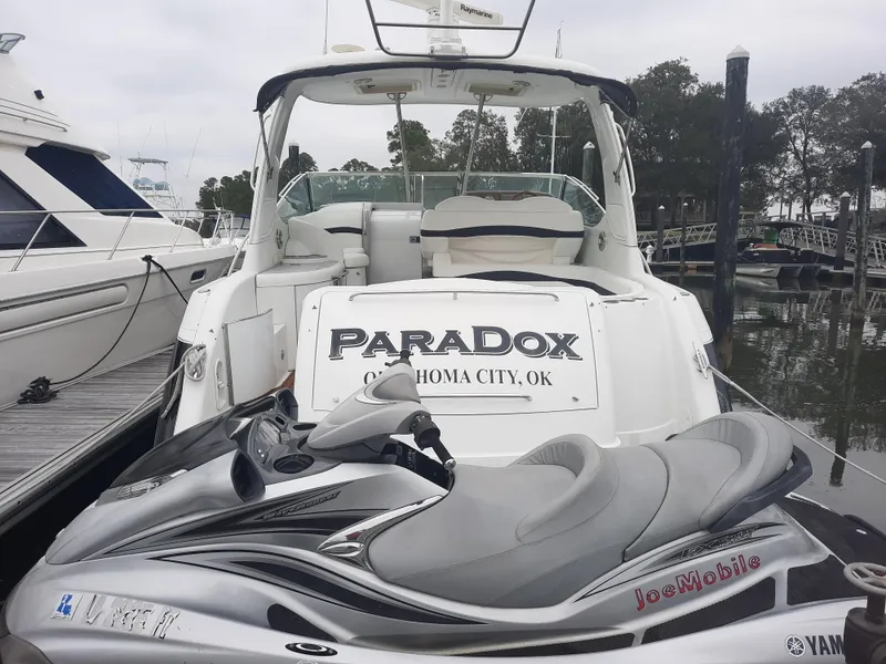 Slide: The Image of 2008 Formula 40 PC boat named Paradox docked with a jet ski. - 4