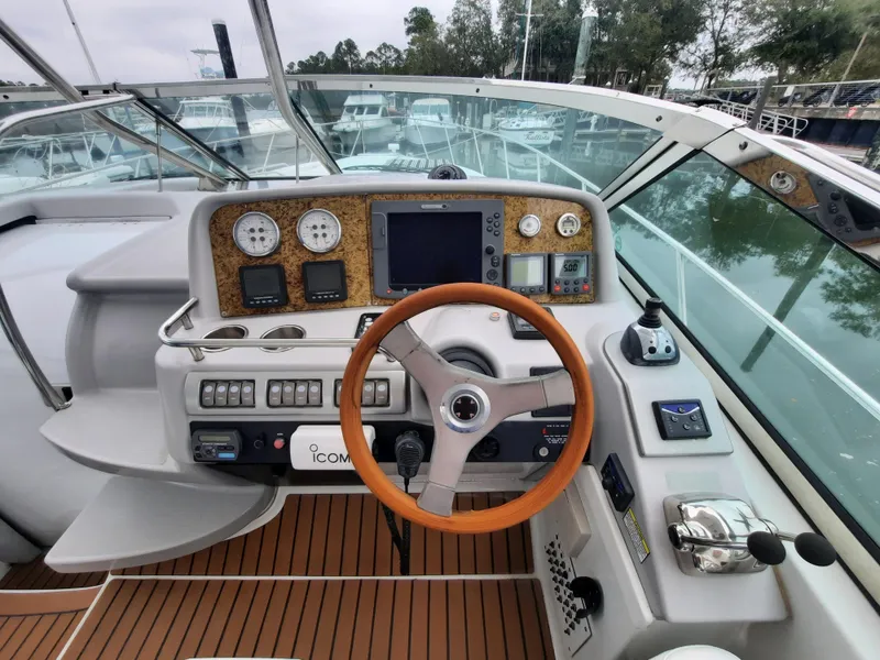 Slide: The Image of 2008 Formula 40 PC yacht helm with wooden steering wheel and modern navigation instruments. - 0