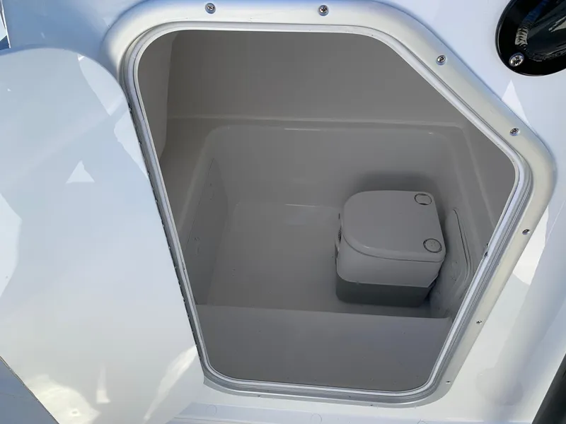 Slide: The Image of 2024 Cape Horn 24 XS boat interior compartment with portable toilet. - 12