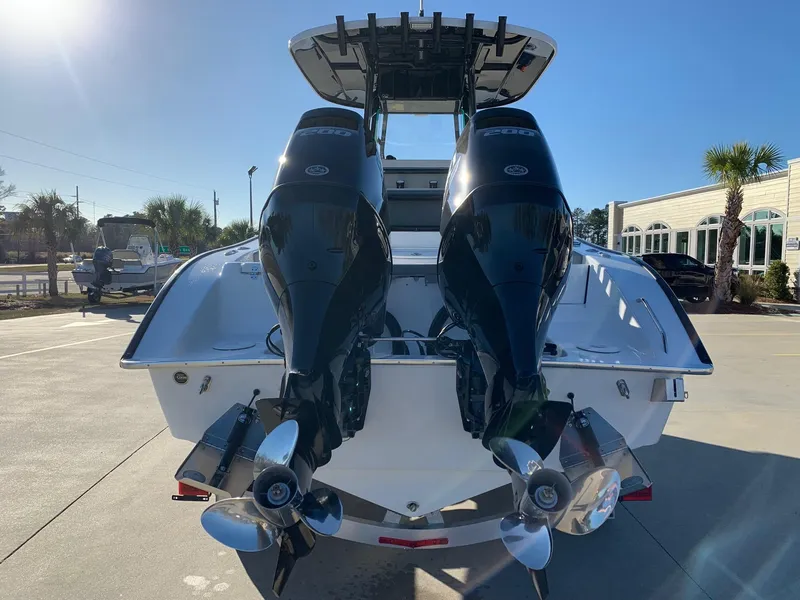 Slide: The Image of 2024 Cape Horn 24 XS boat with twin outboard engines, rear view. - 3
