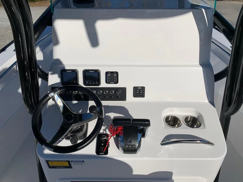 Slide: The Image of 2024 Cape Horn 24 XS boat console with steering wheel and controls. - 8