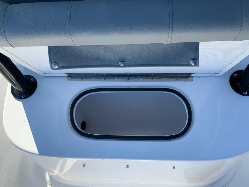 Slide: The Image of 2024 Cape Horn 24 XS boat storage compartment with cushioned seating. - 14