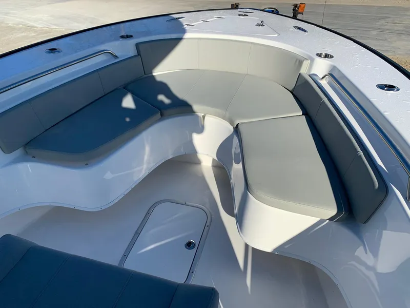 Slide: The Image of 2024 Cape Horn 24 XS boat interior with cushioned seating and storage compartments. - 16