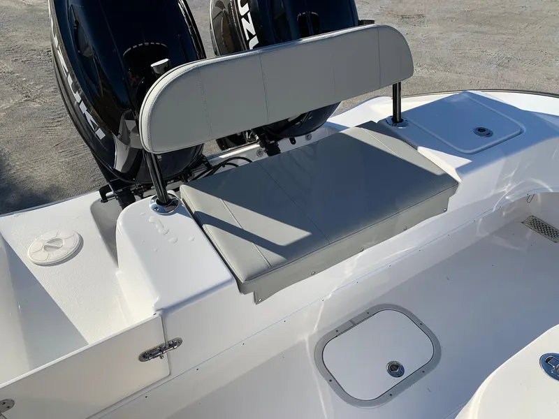 Slide: The Image of 2024 Cape Horn 24 XS boat with cushioned seating and dual outboard motors. - 7