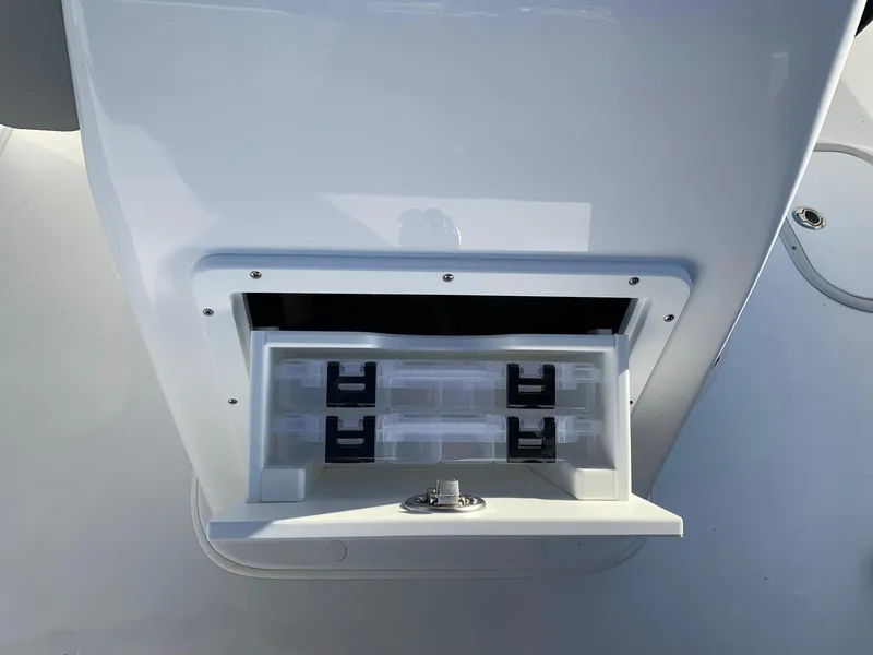 Slide: The Image of 2024 Cape Horn 24 XS boat storage compartment with tackle boxes. - 9