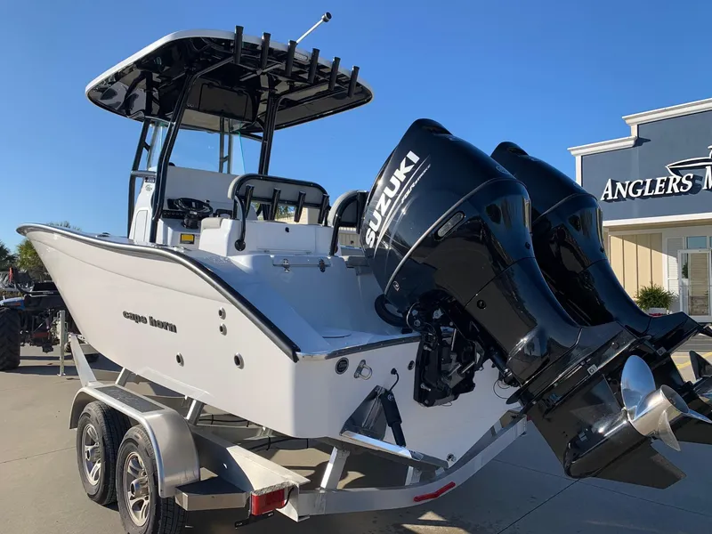 Slide: The Image of 2024 Cape Horn 24 XS boat with dual Suzuki engines on a trailer. - 2