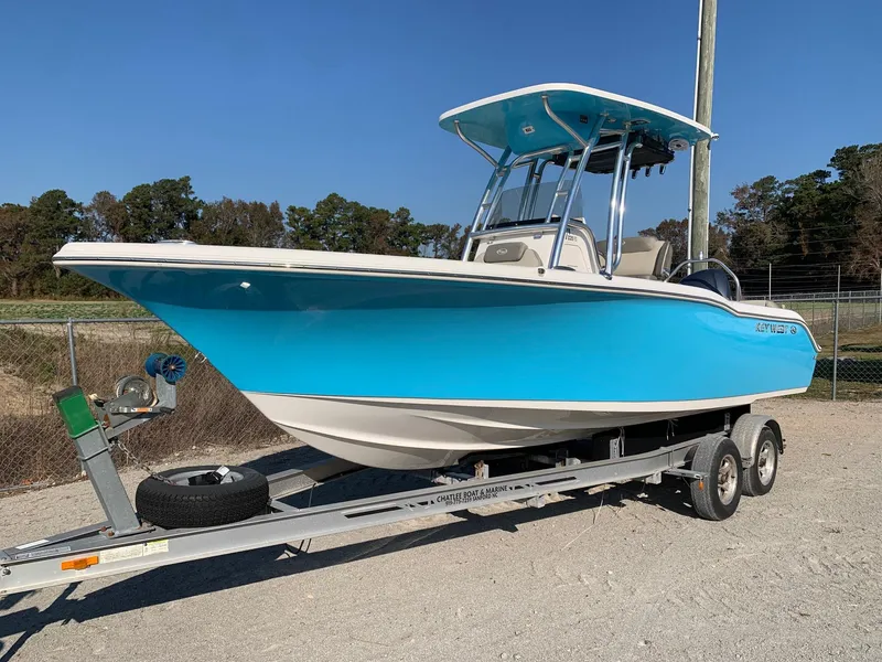 Slide: The Image of 2026 Key West 239 FS boat on trailer, vibrant blue hull, parked outdoors. - 2