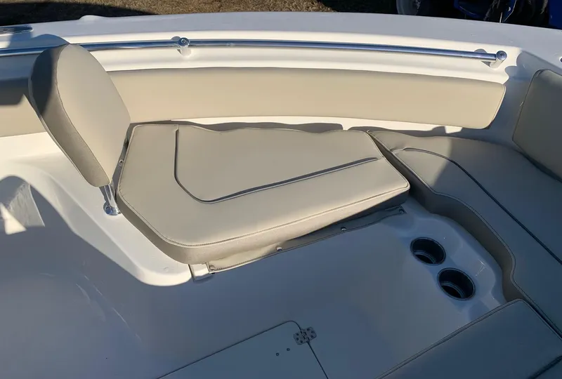 Slide: The Image of 2026 Key West 239 FS boat interior with beige seating and cup holders. - 16