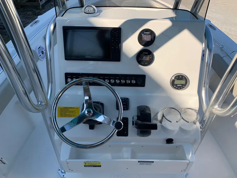 Slide: The Image of 2026 Key West 239 FS boat console with steering wheel, gauges, and navigation screen. - 3