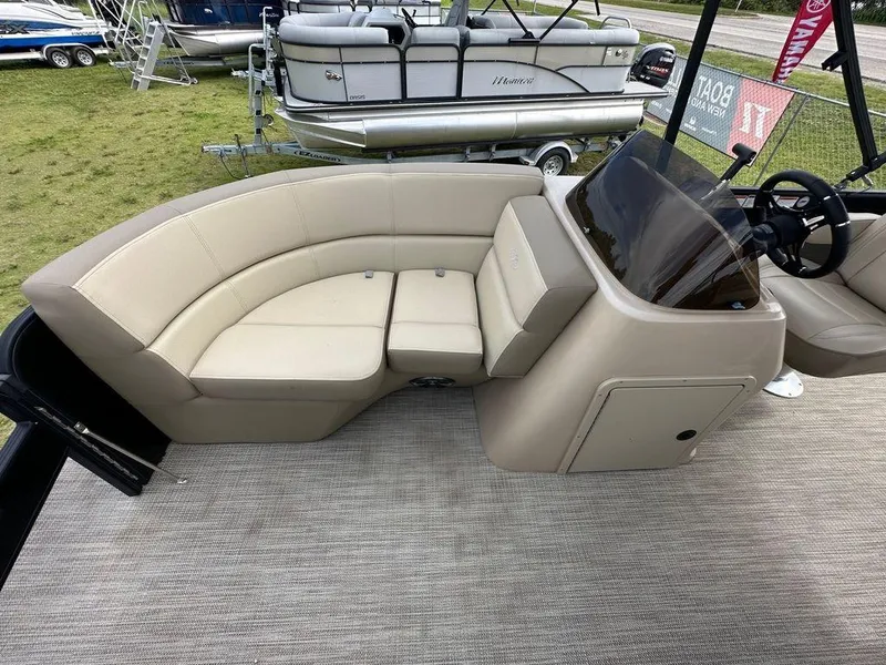 Slide: The Image of 2022 Manitou 20 Aurora LE Angler Full Front Twin Tube boat interior with beige seating. - 10