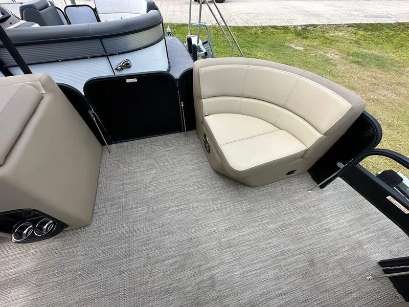 Slide: The Image of 2022 Manitou 20 Aurora LE Angler Full Front Twin Tube boat interior with beige seating. - 11