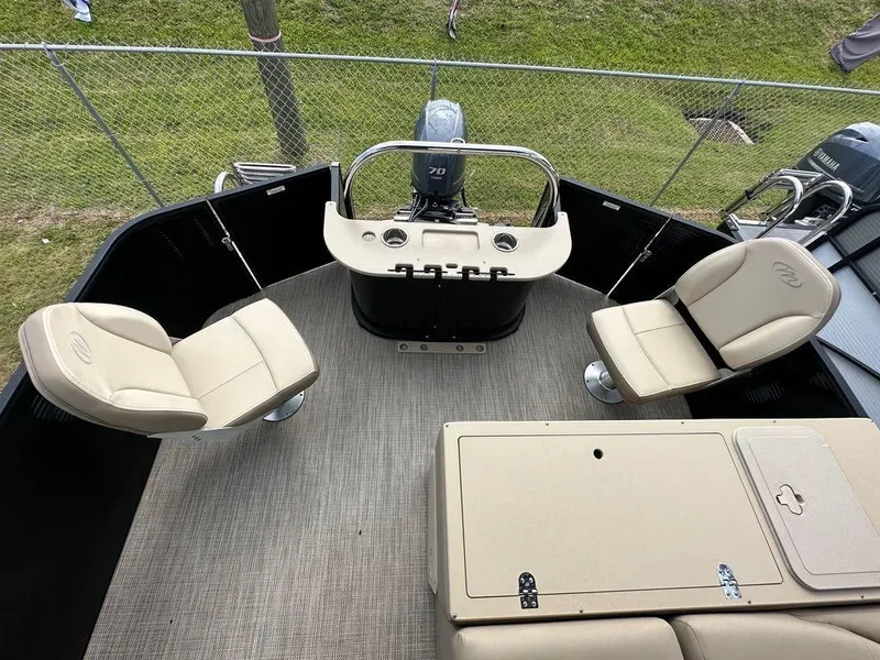 Slide: The Image of 2022 Manitou 20 Aurora LE Angler Full Front Twin Tube interior with beige seating and fishing station. - 15