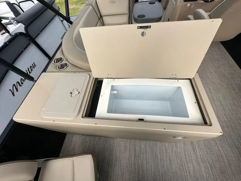 Slide: The Image of 2022 Manitou 20 Aurora LE Angler Full Front Twin Tube boat with open storage compartment. - 16