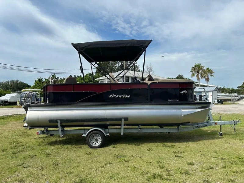 Slide: The Image of 2022 Manitou 20 Aurora LE Angler Full Front Twin Tube pontoon boat on trailer. - 9