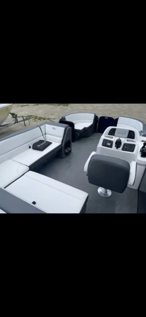 Slide: The Image of 2022 Manitou 18 Aurora LE Twin Tube 25 interior with white and gray seating. - 12