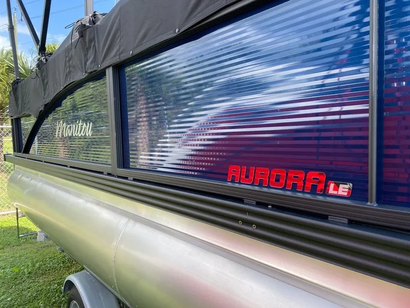 Slide: The Image of 2022 Manitou 18 Aurora LE Twin Tube 25 pontoon boat side view. - 21