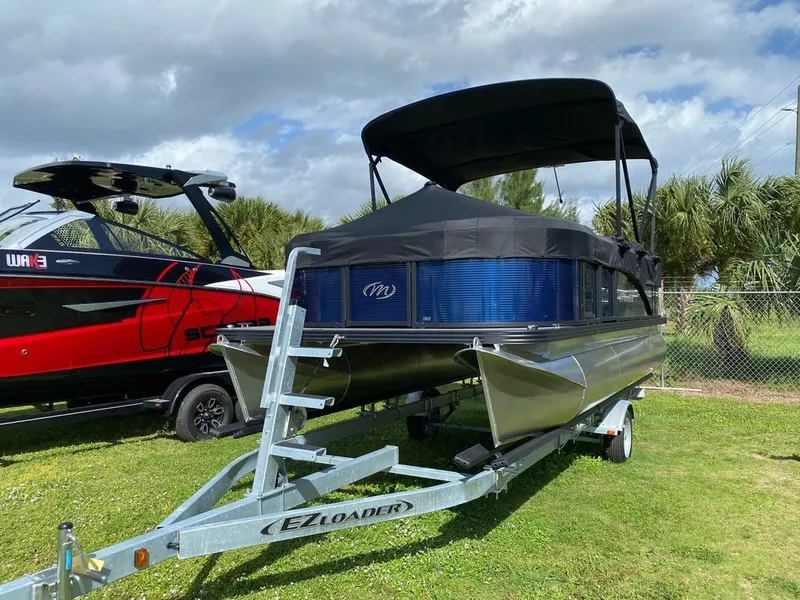 Slide: The Image of 2022 Manitou 18 Aurora LE Twin Tube 25 pontoon boat on EZ Loader trailer. - 4