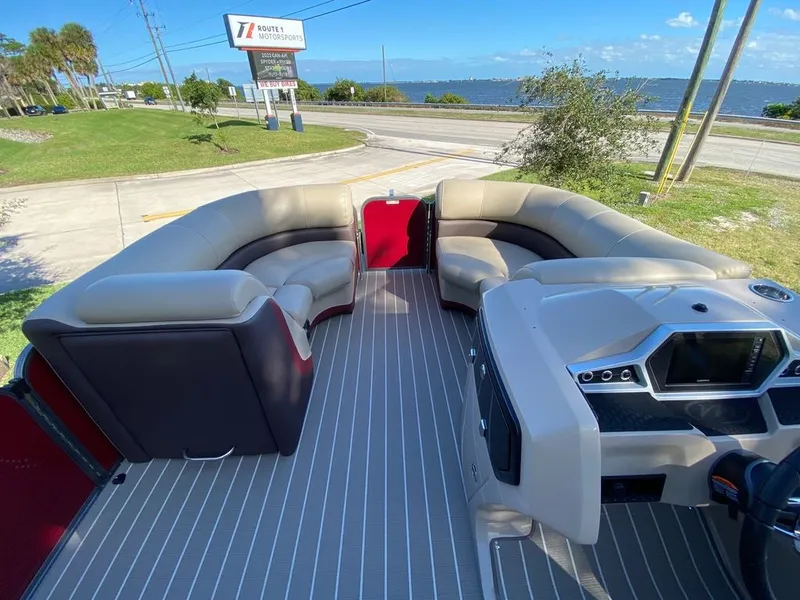 Slide: The Image of 2022 Manitou 23 Oasis SR VP pontoon boat interior with spacious seating and modern dashboard. - 10