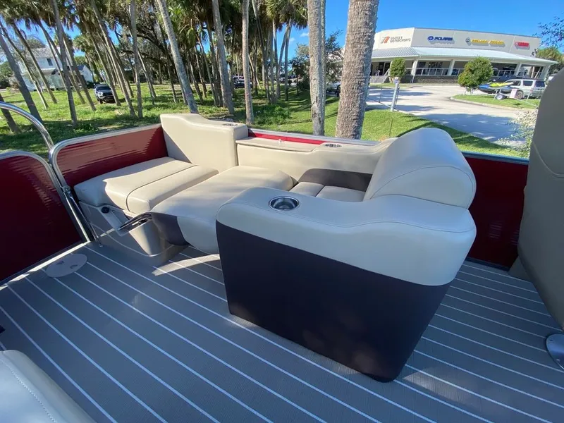 Slide: The Image of 2022 Manitou 23 Oasis SR VP boat interior with comfortable seating and cup holder. - 13