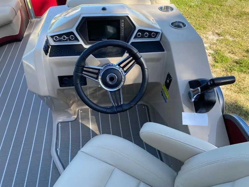 Slide: The Image of 2022 Manitou 23 Oasis SR VP boat dashboard with steering wheel and control panel. - 17