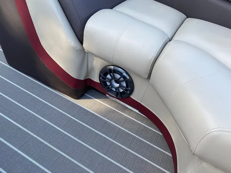 Slide: The Image of 2022 Manitou 23 Oasis SR VP boat interior with beige seats and speaker. - 20