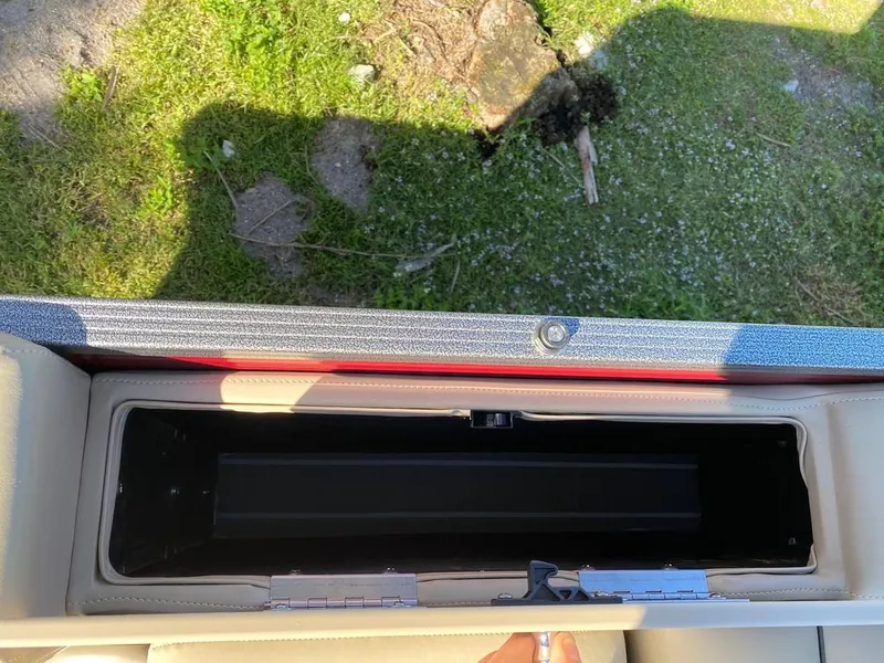 Slide: The Image of Storage compartment of 2022 Manitou 23 Oasis SR VP pontoon boat. - 23
