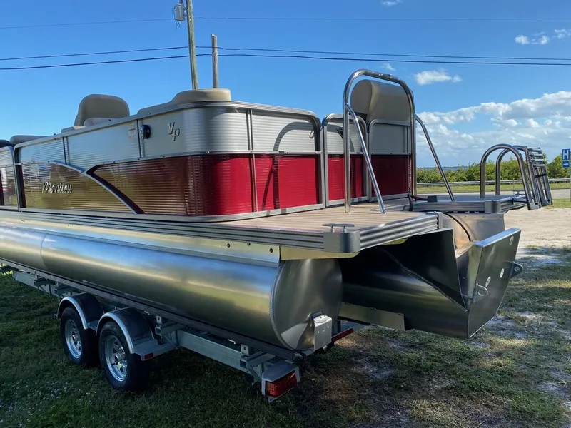 Slide: The Image of 2022 Manitou 23 Oasis SR VP pontoon boat on a trailer, rear view. - 3