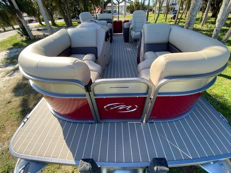 Slide: The Image of 2022 Manitou 23 Oasis SR VP pontoon boat with beige seating and red exterior. - 8