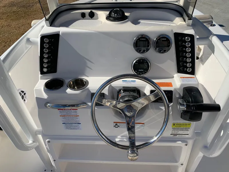 Slide: The Image of 2024 Robalo 226 Cayman boat console with steering wheel and controls. - 6