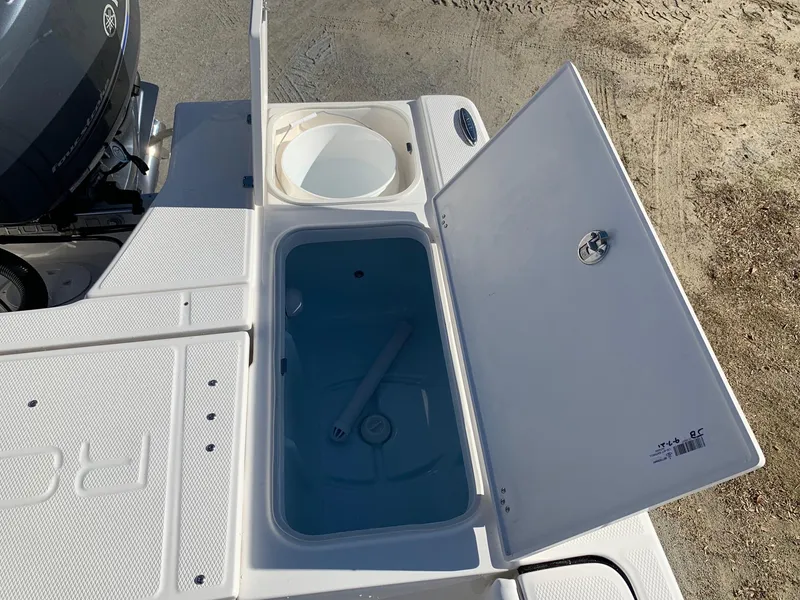 Slide: The Image of 2024 Robalo 226 Cayman boat storage compartments and livewell. - 10