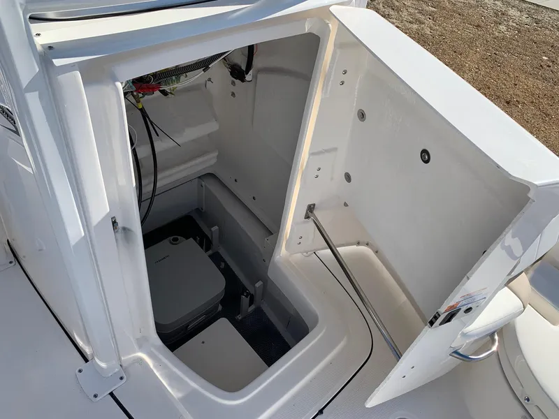 Slide: The Image of 2024 Robalo 226 Cayman boat interior storage compartment with open hatch. - 17
