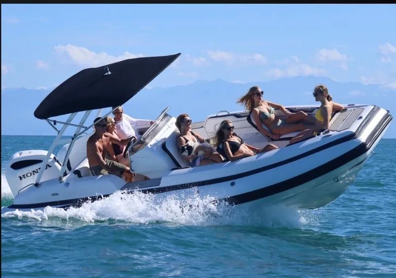 Slide: The Image of 2025 Walker Bay WB 22 boat cruising with passengers on a sunny day. - 11