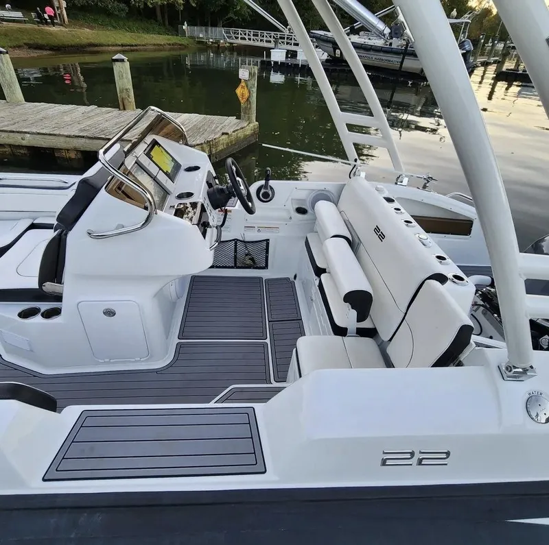 Slide: The Image of 2025 Walker Bay WB 22 boat interior with modern dashboard and white seating. - 4