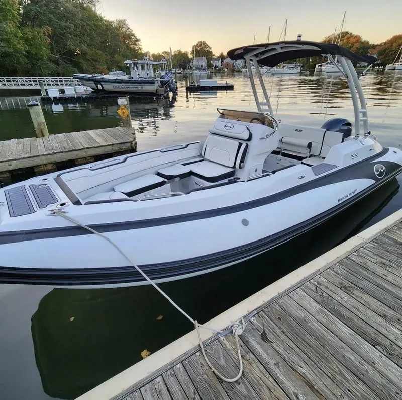 Slide: The Image of 2025 Walker Bay WB 22 boat docked at a marina. - 2