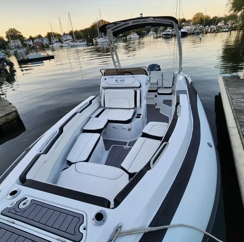 Slide: The Image of 2025 Walker Bay WB 22 boat docked at a marina with scenic background. - 3