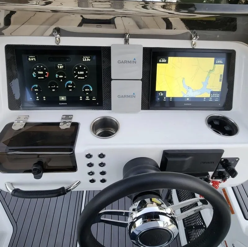 Slide: The Image of Walker Bay WB 22 2025 boat dashboard with Garmin navigation and control screens. - 5