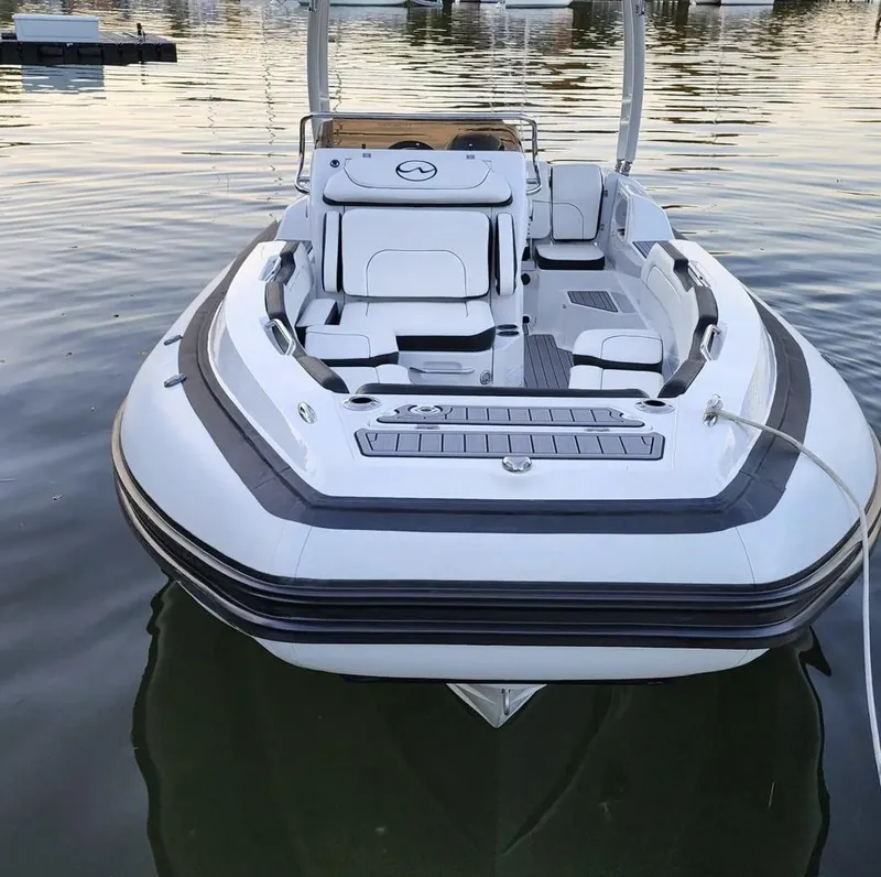 Slide: The Image of 2025 Walker Bay WB 22 boat docked on calm water. - 8