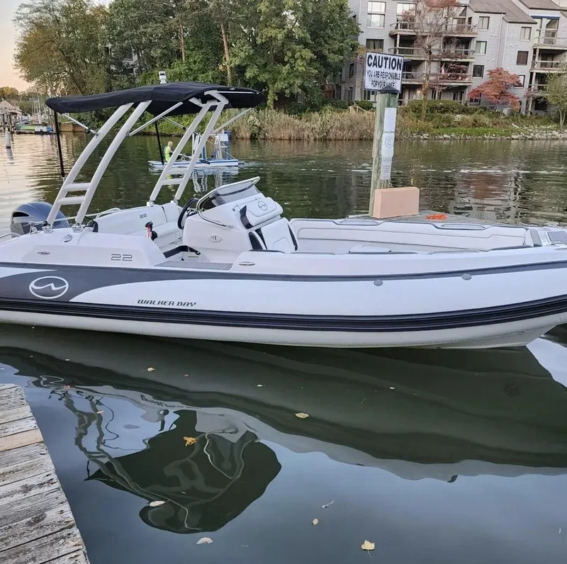 Slide: The Image of Walker Bay WB 22 boat docked by the water, 2025 model. - 9