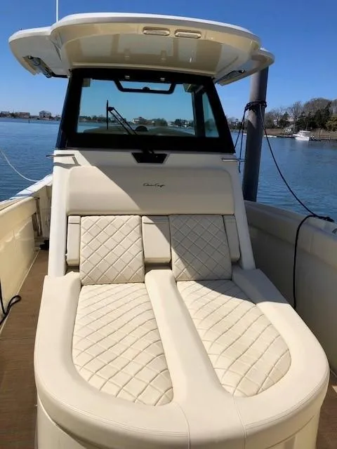 Slide: The Image of 2021 Chris-Craft Catalina 30 boat with luxurious seating and waterfront view. - 10