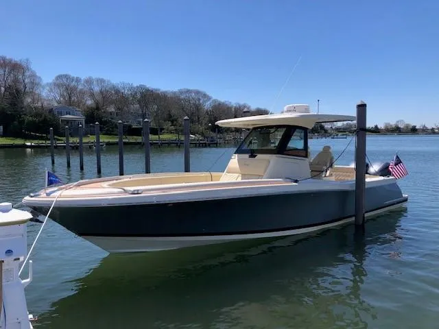 Slide: The Image of 2021 Chris-Craft Catalina 30 boat docked in a serene marina. - 2