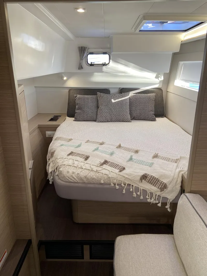 Slide: The Image of 2025 Lagoon 40 yacht cabin with cozy bed and modern decor. - 9