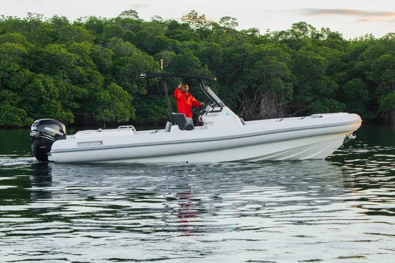 Slide: The Image of 2024 Northstar Orion 8 boat with Yamaha outboard motor, docked under clear blue sky. - 3