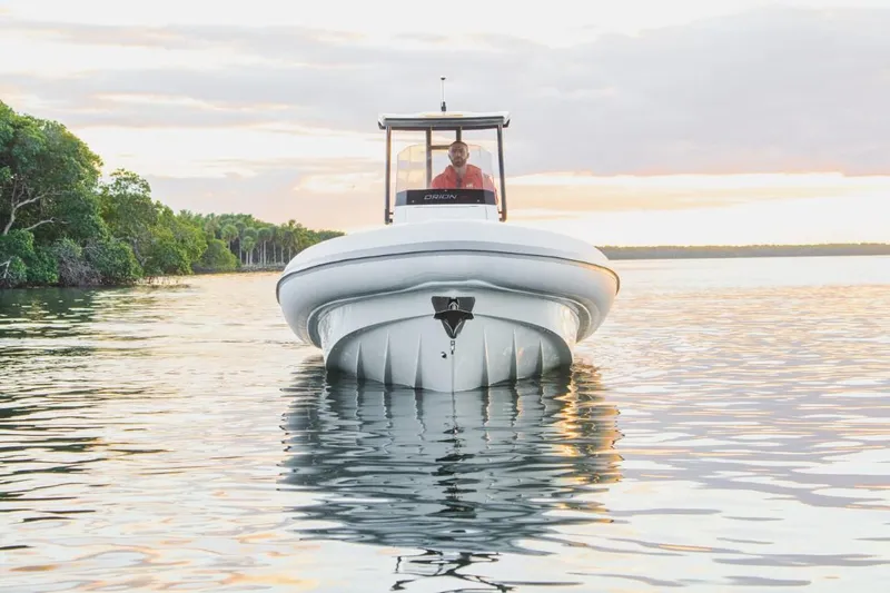 Slide: The Image of 2024 Northstar Orion 8 boat interior with gray seating and Yamaha engine at marina. - 5
