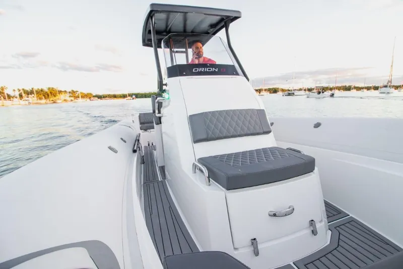 Slide: The Image of 2024 Northstar Orion 8 boat with sleek design and modern seating under a clear blue sky. - 8