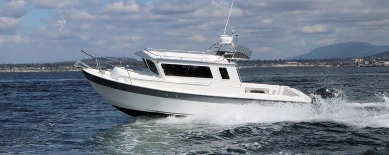 The Image of 2026 SeaSport Kodiak 2600 boat cruising on open water under a cloudy sky. - 0