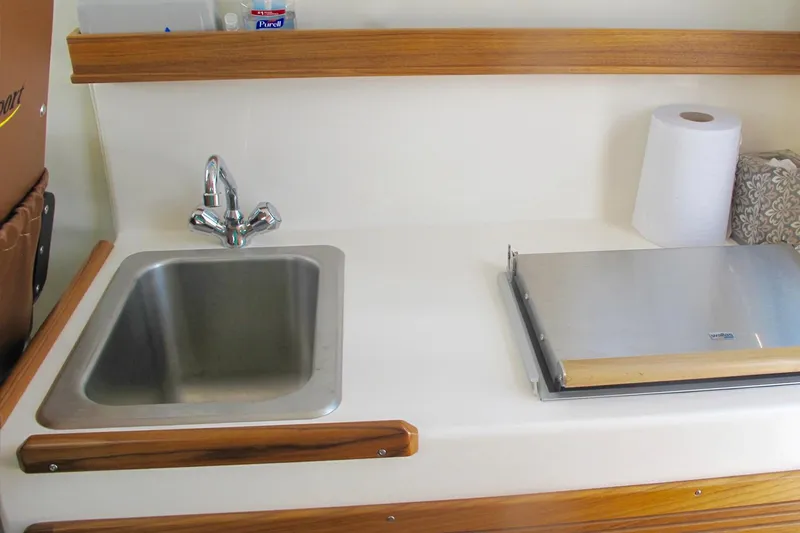Slide: The Image of Compact kitchen area in 2026 SeaSport Kodiak 2600 boat with sink and counter space. - 7