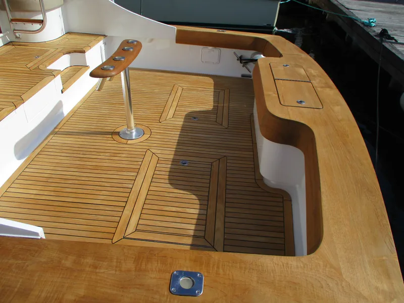 Slide: The Image of 2008 Custom Carolina 53 Sculley teak deck with rod holders and storage compartments. - 21