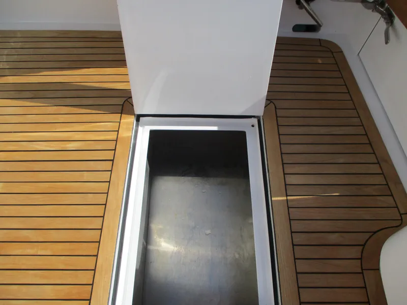 Slide: The Image of Open hatch on the deck of a 2008 Custom Carolina 53 Sculley boat. - 28